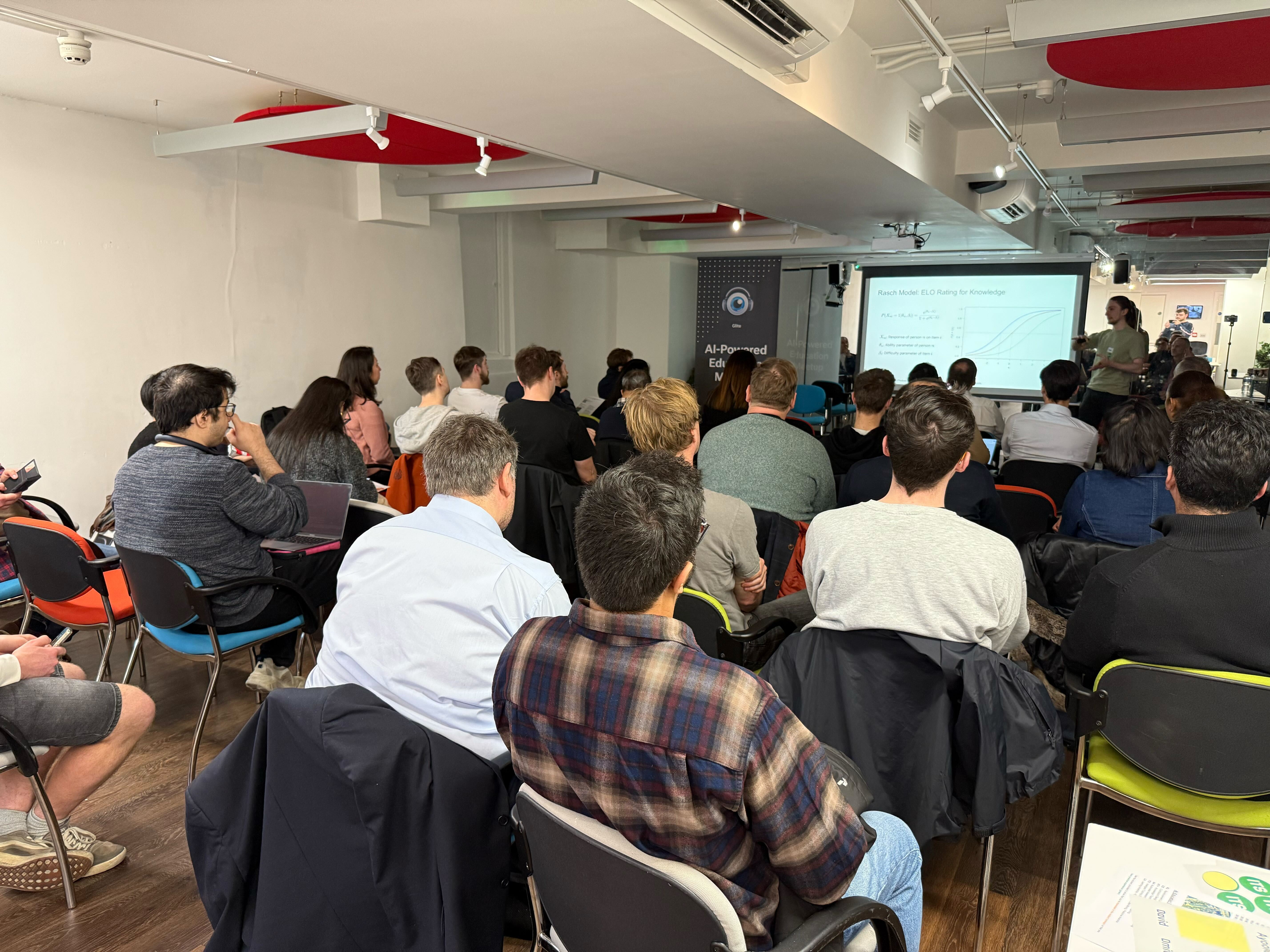 A presentation on the Rasch model and learner knowledge, with the audience seated in the Warren Centre.